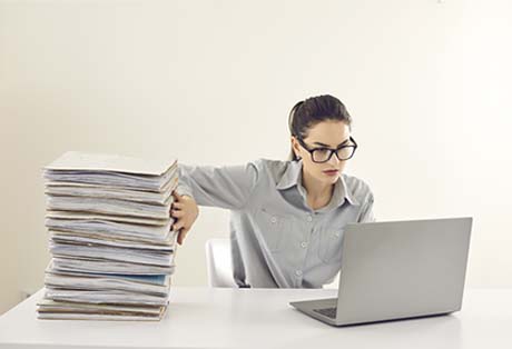 Woman with documents and laptop